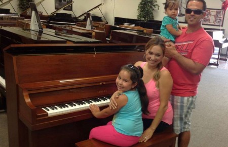 Robert, Lily and Family and their Yamaha Studio Piano.