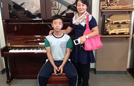 Wang and her son with their new Starr Piano