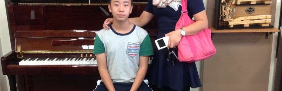 Wang and her son with their new Starr Piano