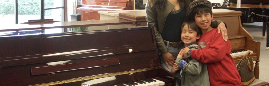 Mytien and family with their Young Chang console